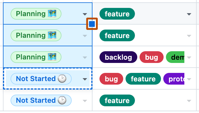 Screenshot showing two columns on a table layout. Three cells are selected. The blue handle, on the lower right of the cell, is highlighted with an orange outline.